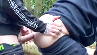 Scally twink leaned over a log in the rain Trackies down, taking it deep