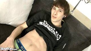 Lean brunette strokes hard on the grey couch
