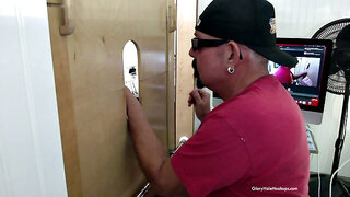 Ebony man sucks cock through a gloryhole